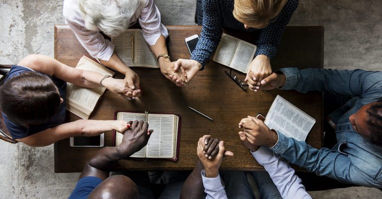 Prayer circle with hands clasped