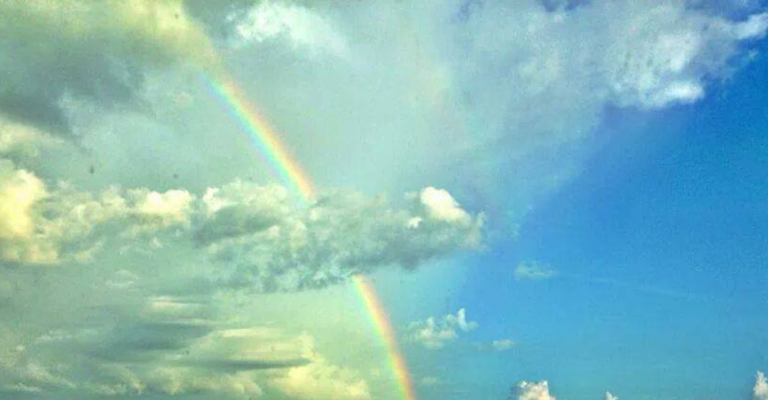 Rainbow shining through clouds